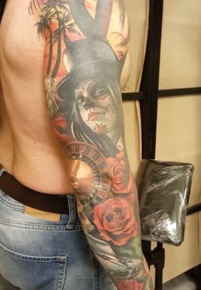 Realismo color, Christian Kurt Bieber. Tatuaje en brazo de juego y catrina.